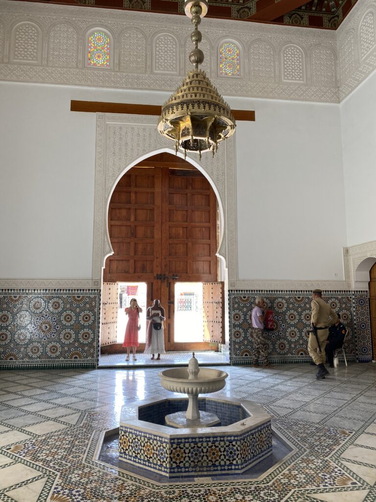 Inside of former mosque with fountain in center of mosaic tiled room