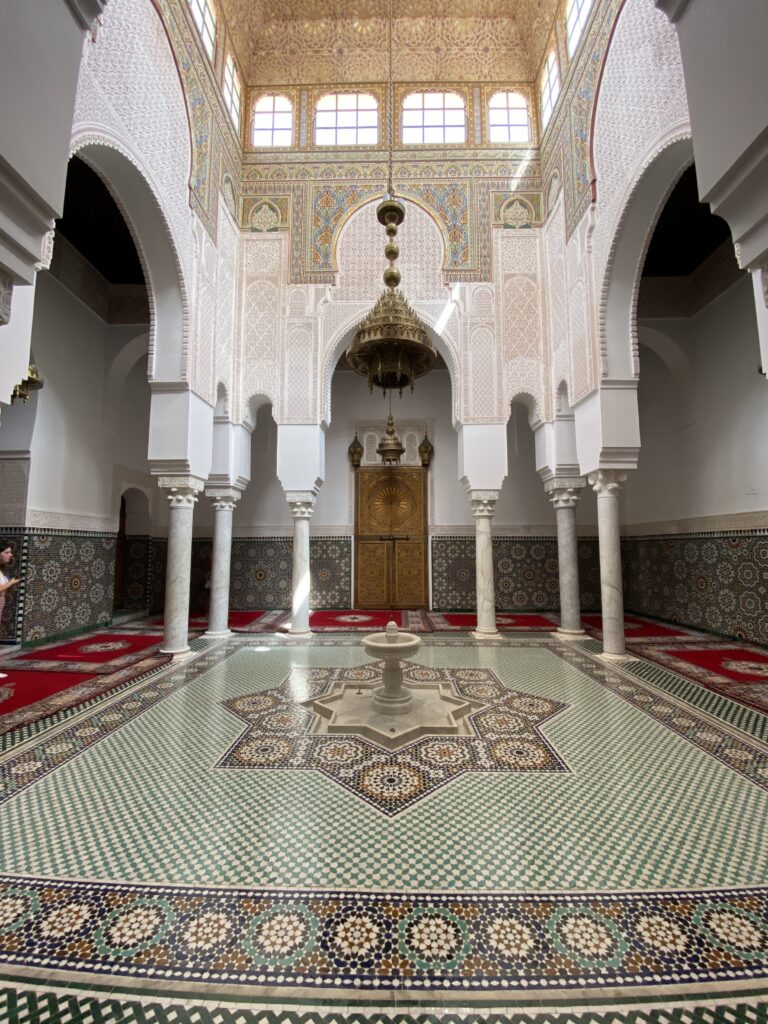 Detailed mosaic tiles and columns inside Moroccan former mosque