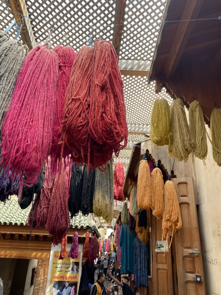 Multicolored yarn hanging from souks in Fez Morocco medina