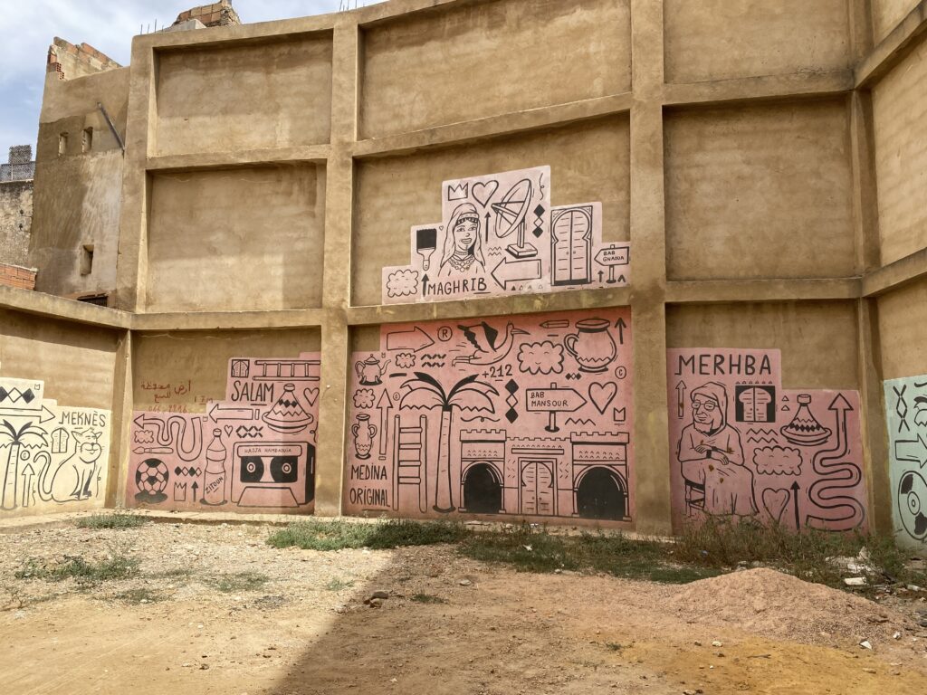 Cartoon street art on walls inside the Meknes Morocco medina