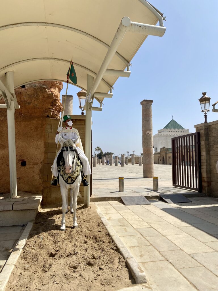 Guard on horseback at entrance to mausoleum and archeological site in Rabat Morocco
