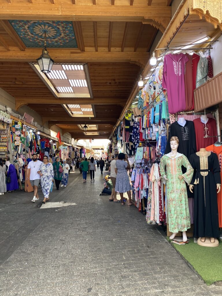 Medina street lined with vendors selling djellabas in Rabat Morocco