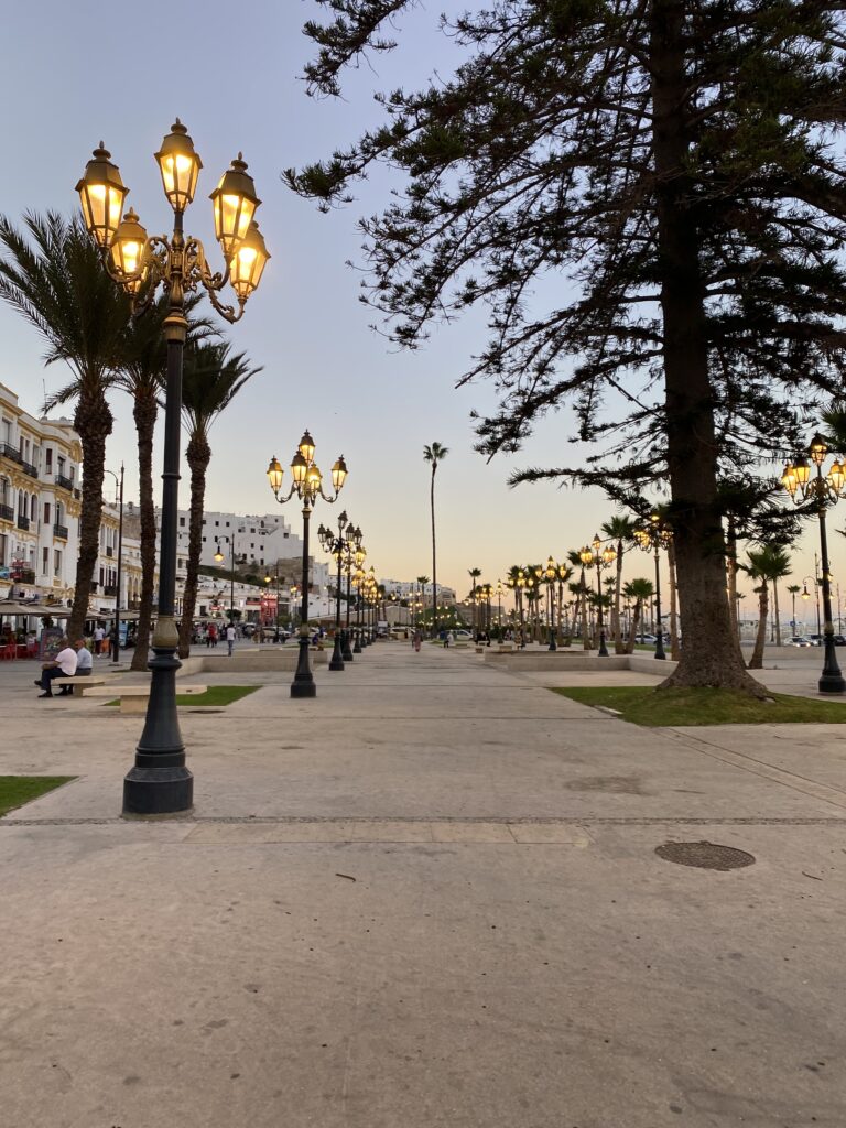 Waterfront walkway in Tangier Morocco lined with yellow street lamps and trees