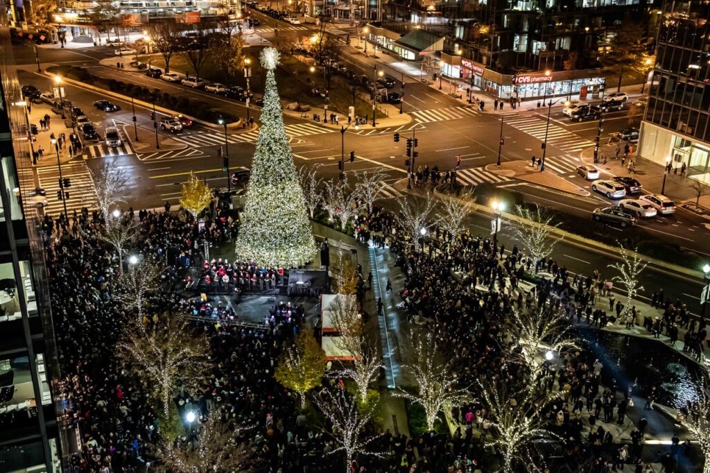 Aerial view of tall Washington DC Christmas tree in a plaza full of holiday lights 
