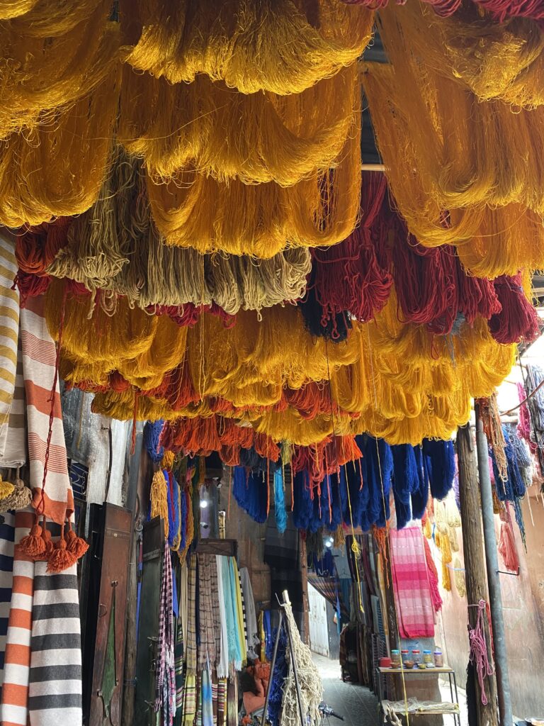 Colorful yarn hanging from the ceiling in the Marrakesh medina