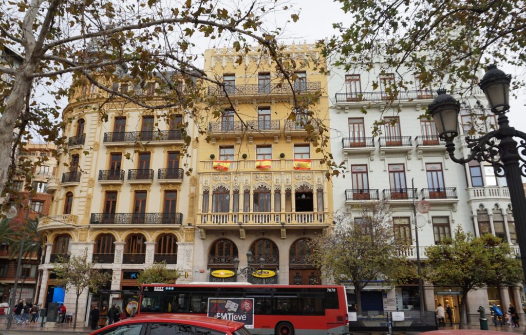 Spanish-style row of buildings with Spanish flags hanging on balconies