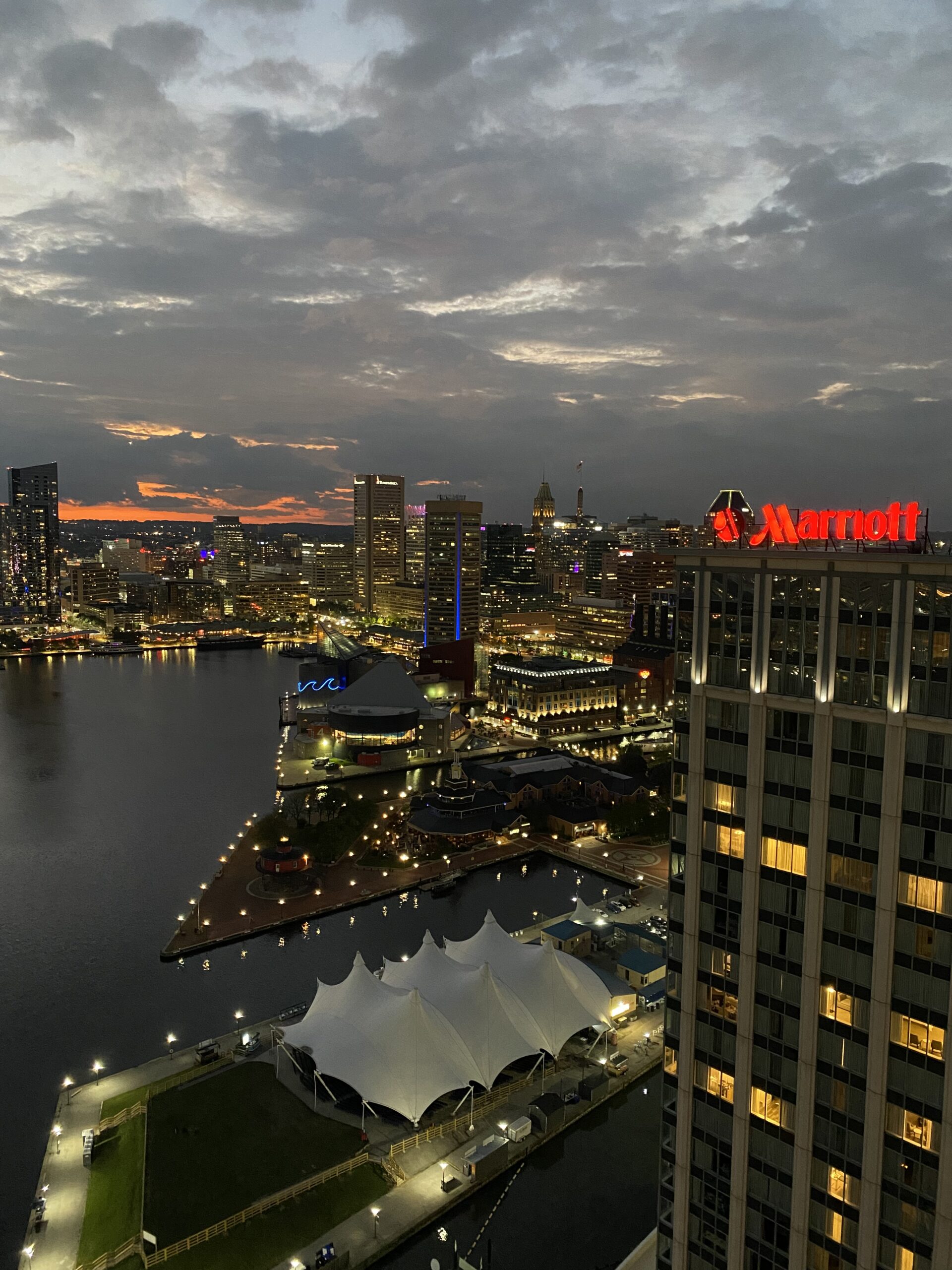 View of buildings and a harbor at night in Baltimore Maryland.