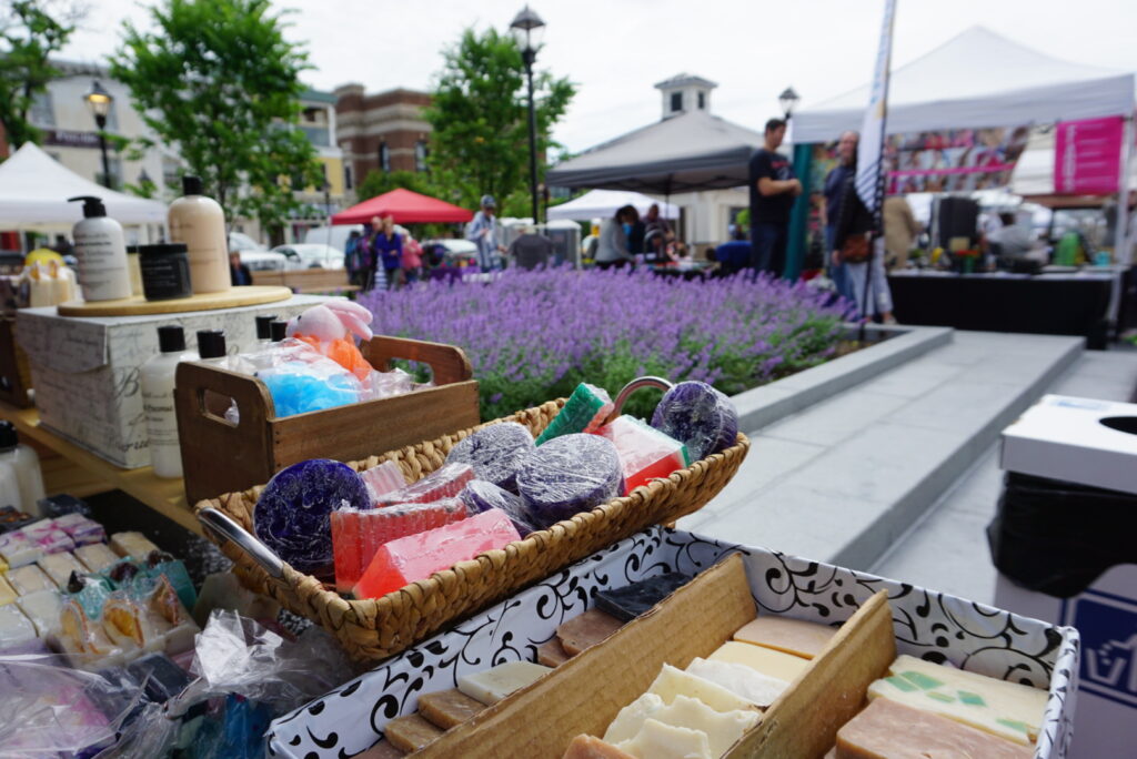 Display of soaps and a patch of lavender in the background