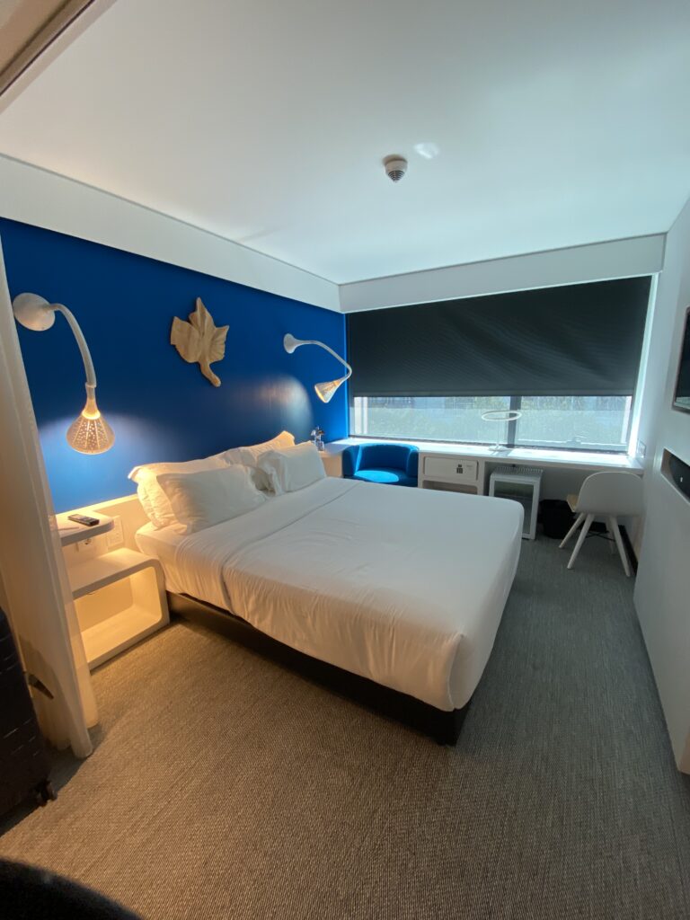 Inside of a hotel room decorated in blue and white