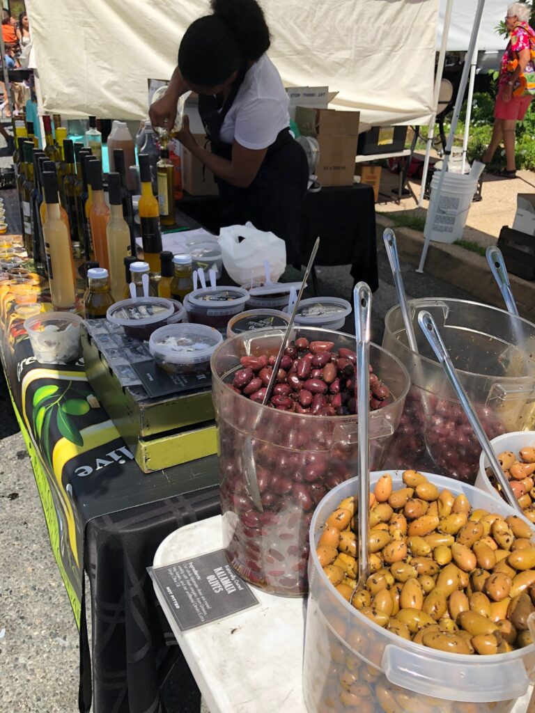 Marinated olives in buckets for sale at farmers market in Baltimore