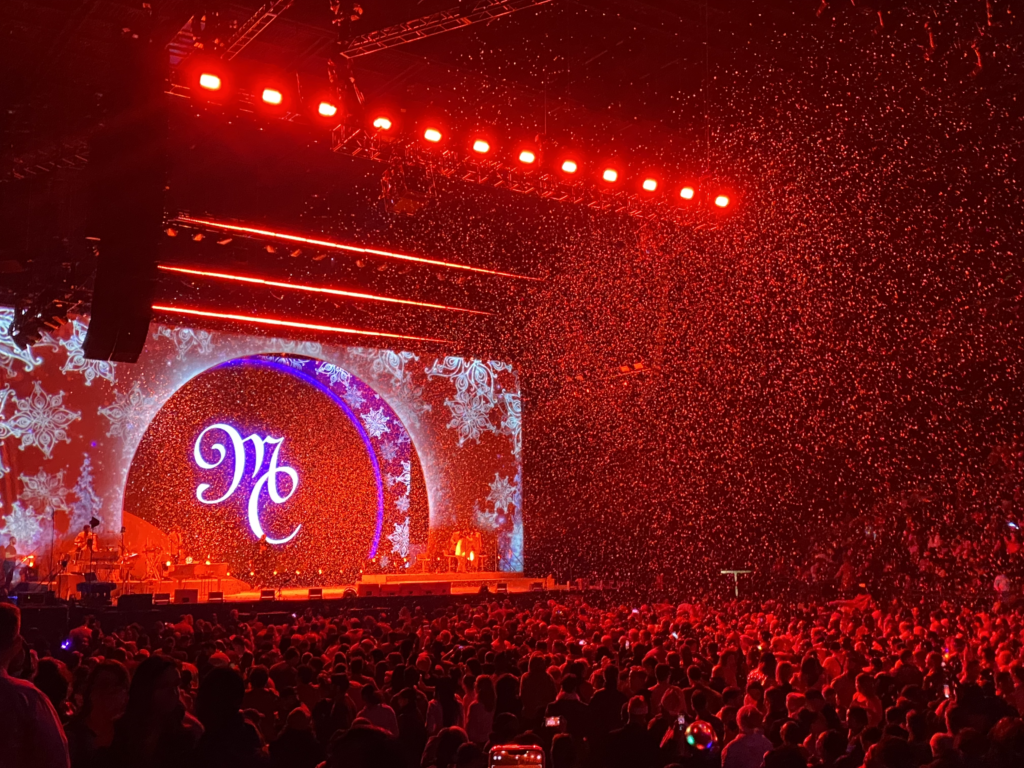 Mariah Carey concert stage with red lights and confetti in the air