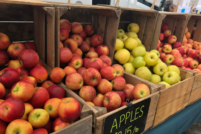 Boxes of apples for sale at farmers markets in Baltimore