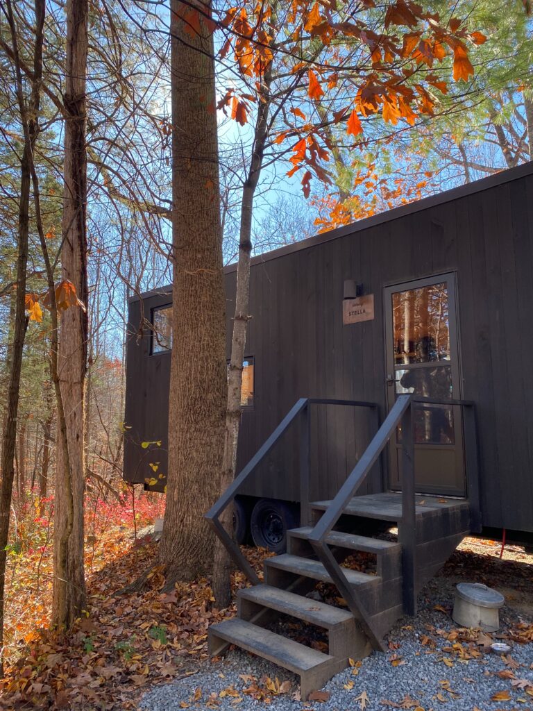 Small cabin amid trees with autumn leaves at a Getaway House Washington DC outpost