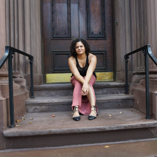 Woman sitting on the stoop of a Baltimore City historic home
