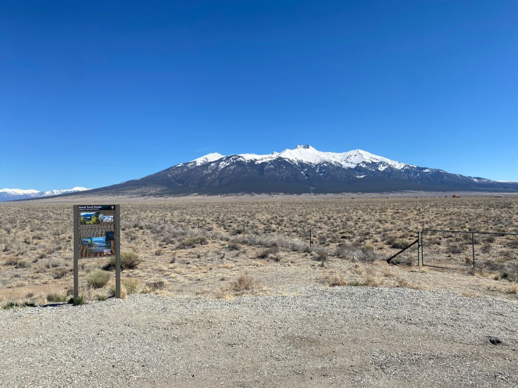 Desert with Colorado snow-capped mountains in background