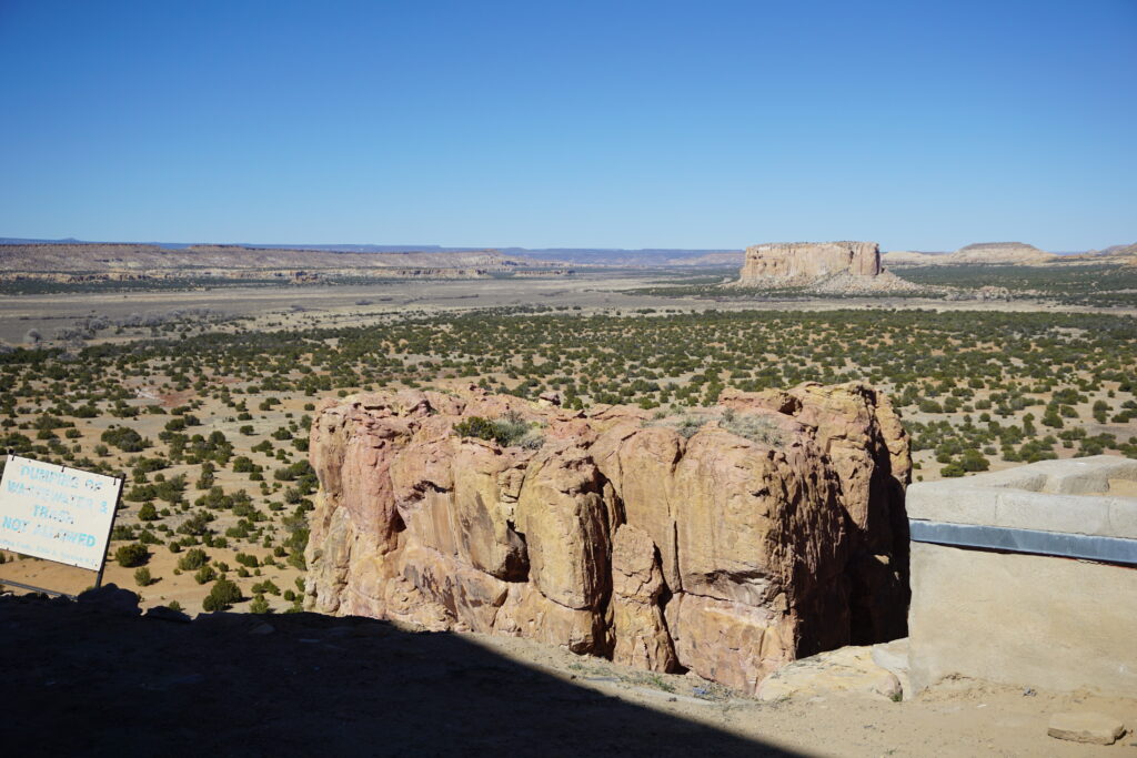 View of desert land and a large mesa in the distance