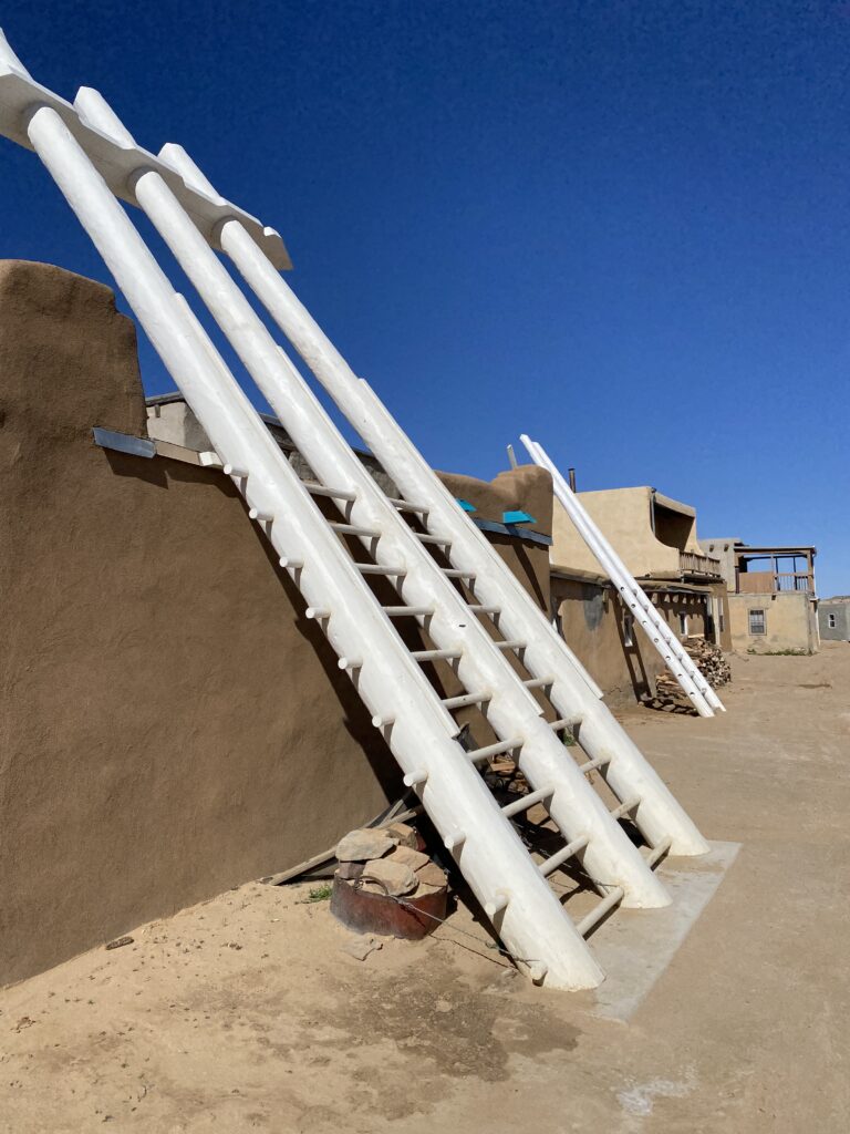 Tall wooden ladder leaned against an adobe home in Acoma Pueblo New Mexico