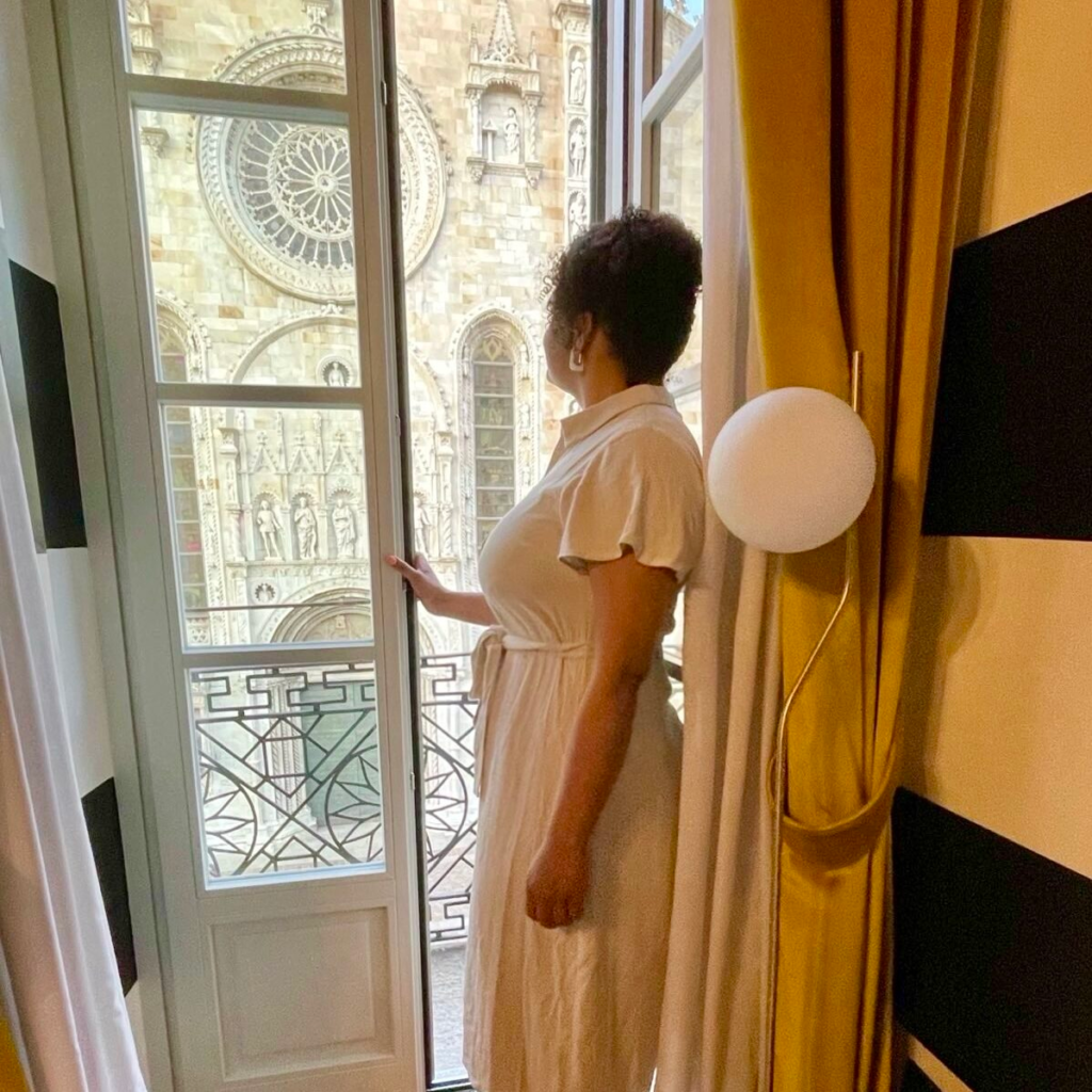 Woman looking out of balcony windows