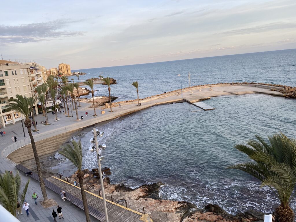 Overhead view of the Torrevieja Spain coast line with boardwalk and rocky cove