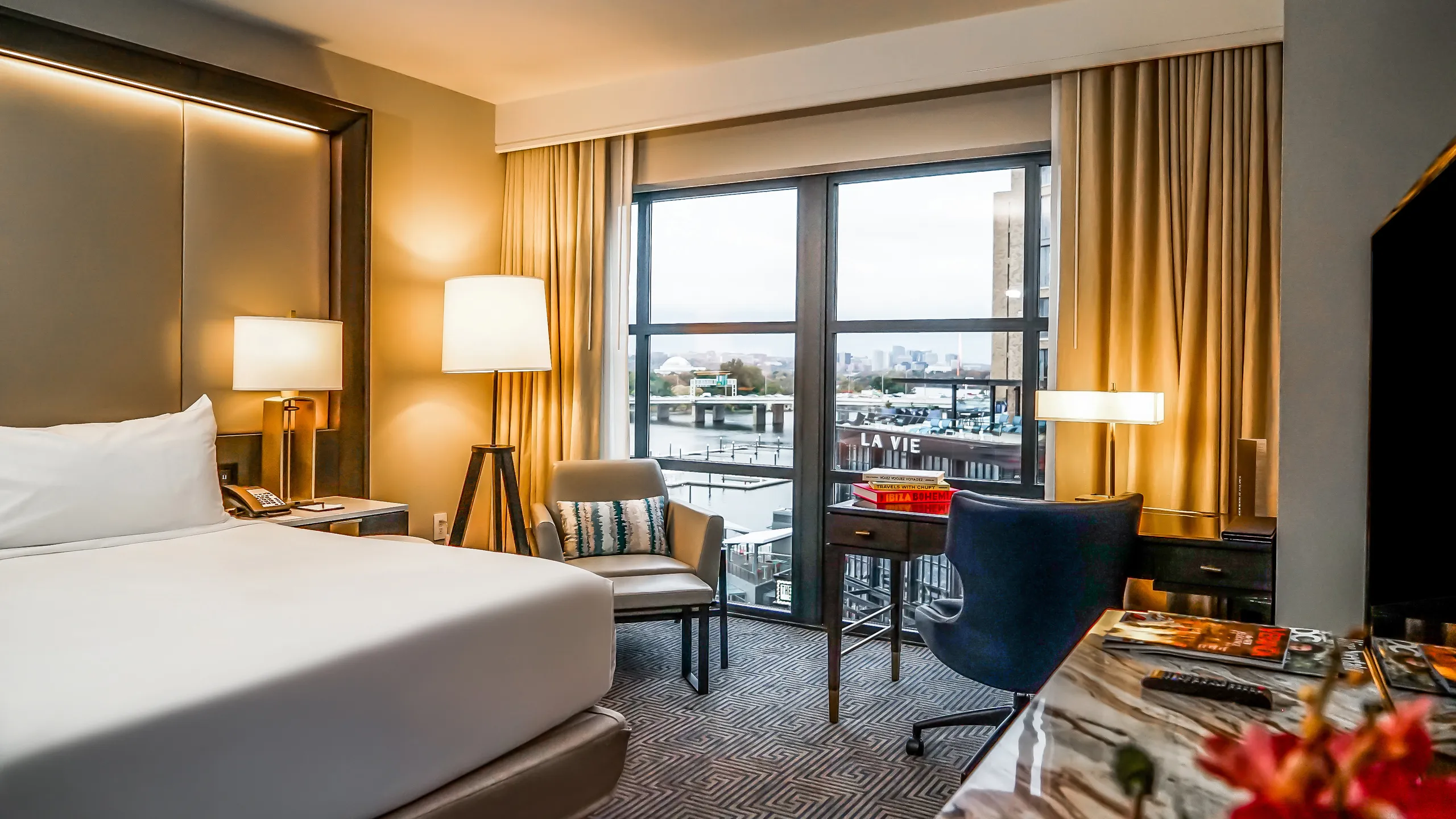 Inside of hotel guest room with view of Washington DC's The Wharf from the large windows