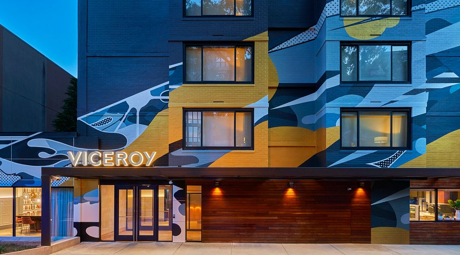 Outside of Viceroy hotel in Washington DC featuring blue and yellow artwork on the brick facade