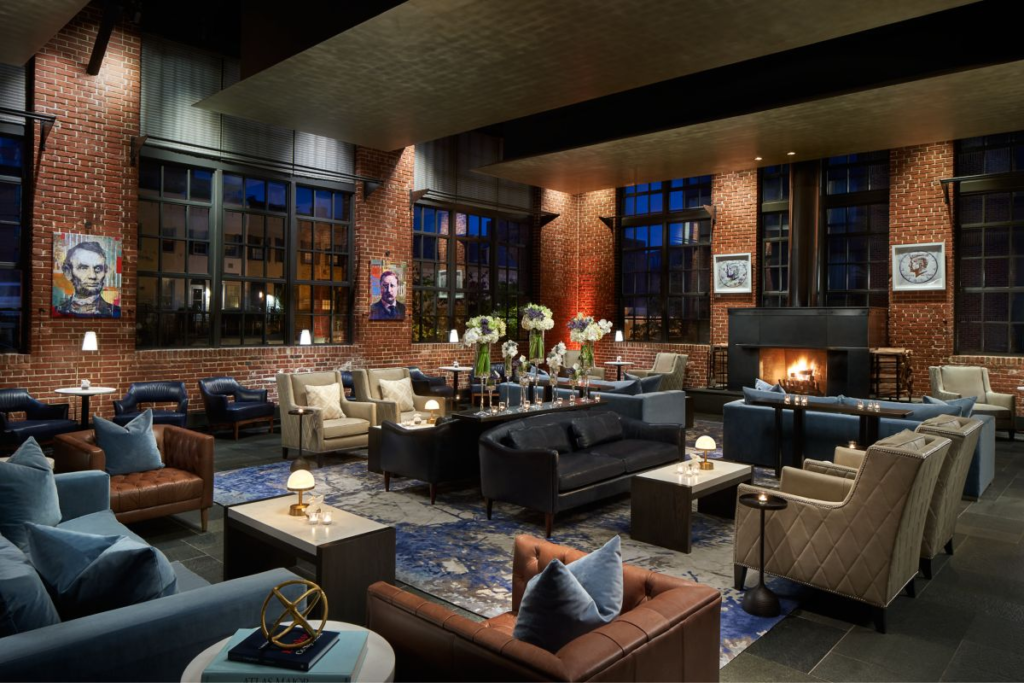 Ritz-Carlton lounge area with brick walls, sofas and armchairs, and large windows
