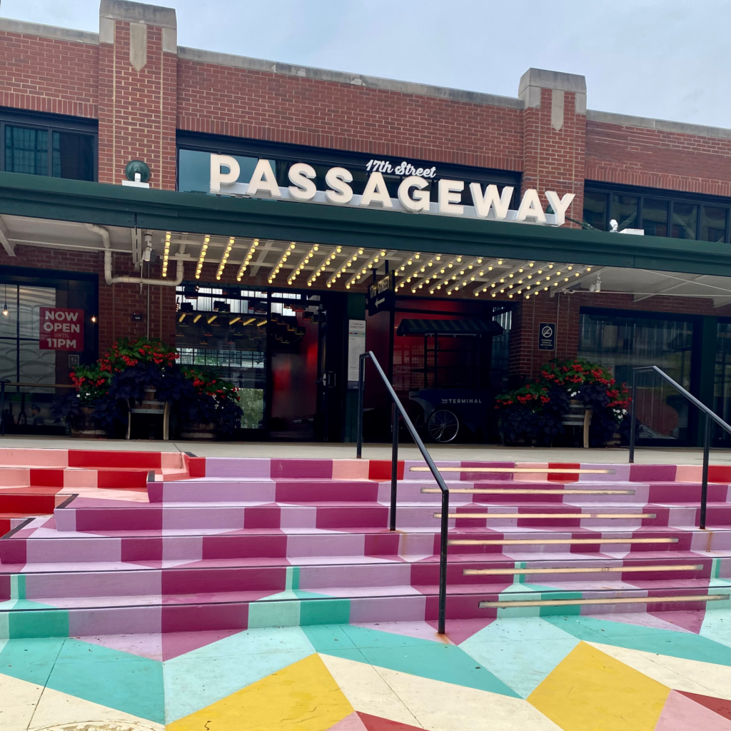 Front of an indoor market with colorfully painted cement steps